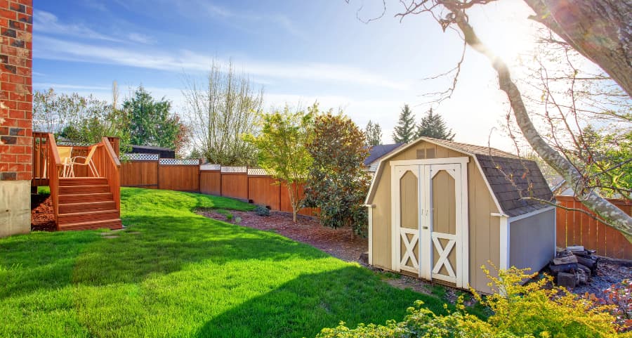 Fenced backyard with storage shed in Oklahoma City